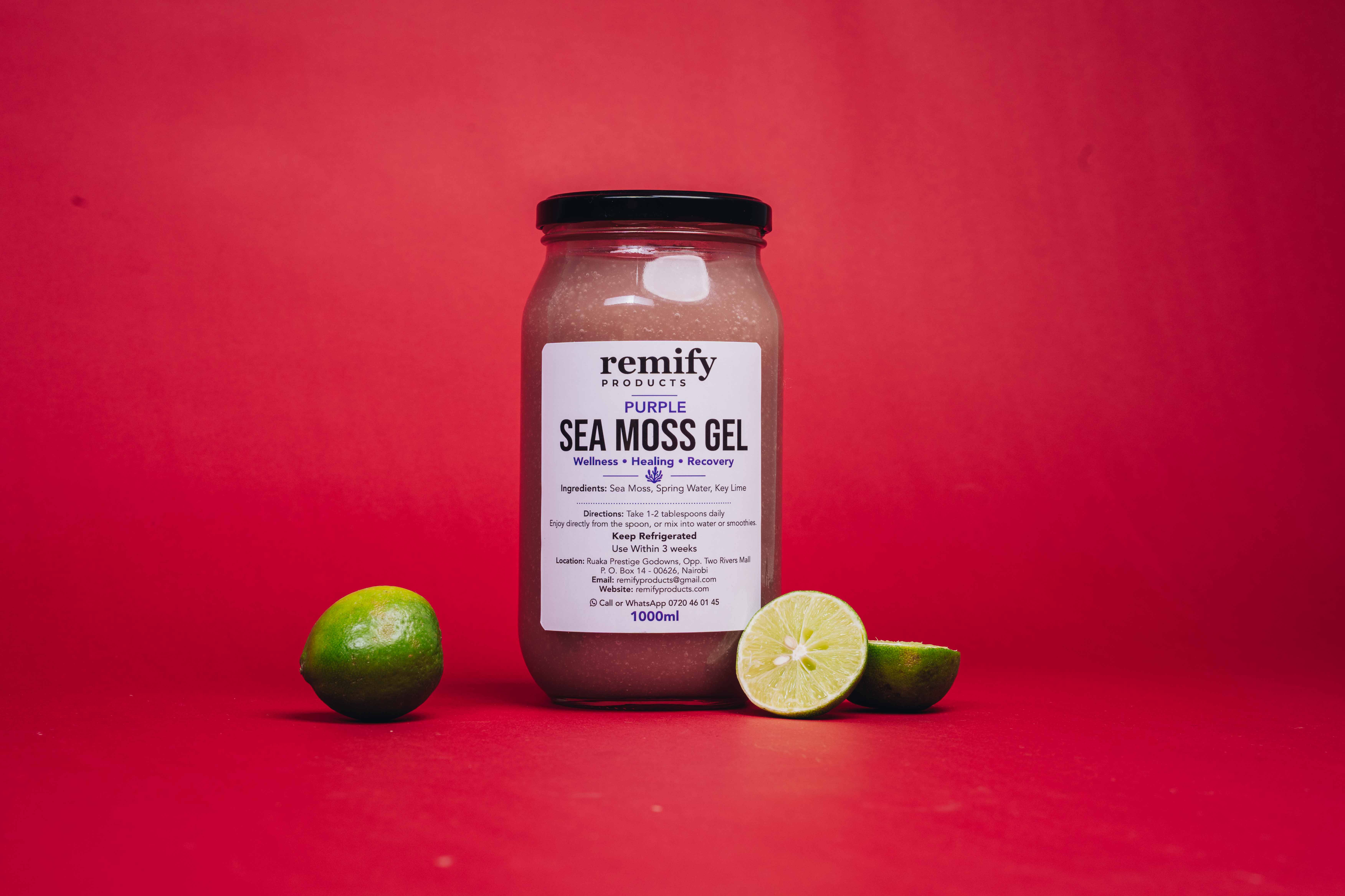 A jar of Remify purple sea moss gel resting beside raw ocean-harvested sea moss