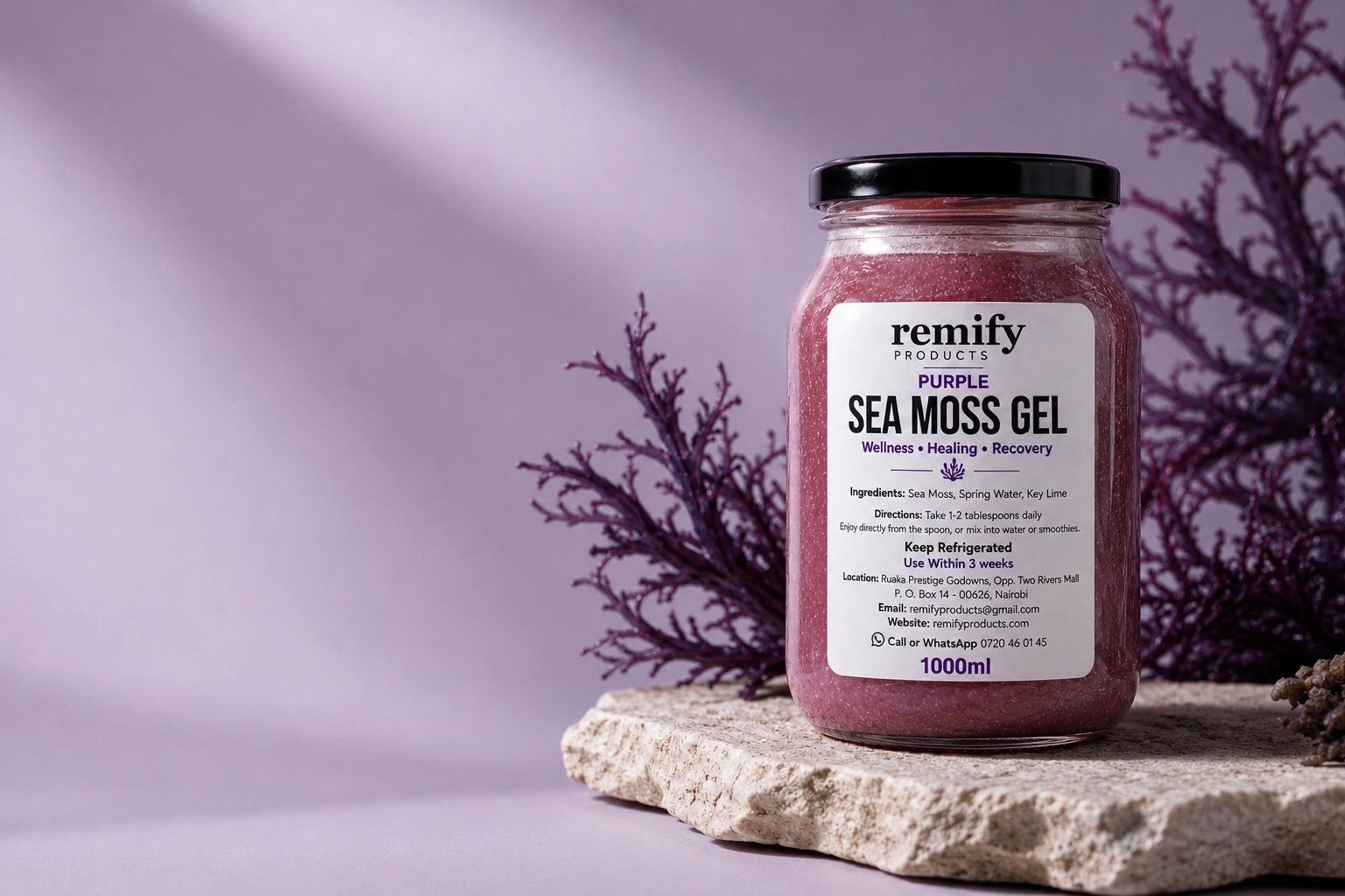 A jar of Remify purple sea moss gel resting beside raw ocean-harvested sea moss